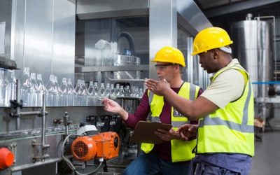 Two factory workers monitoring the production