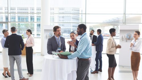Business people discussing over documents at table during a seminar Business people discussing over documents at table during a seminar